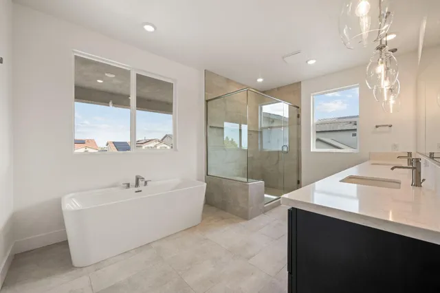 a spacious bathroom with a bathtub sink and mirror