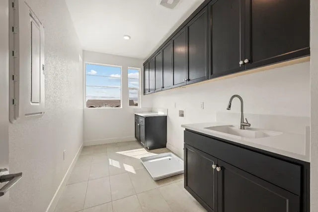 a kitchen with a sink cabinets and appliances