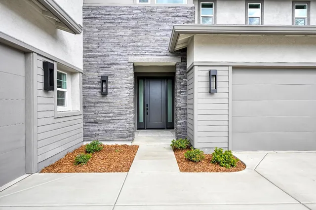 a front view of a house with garden