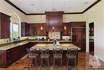 3402 Deep Waters Court Simi Valley, CA 93065 - Photo 8 of 48 a kitchen with a table chairs sink and cabinets