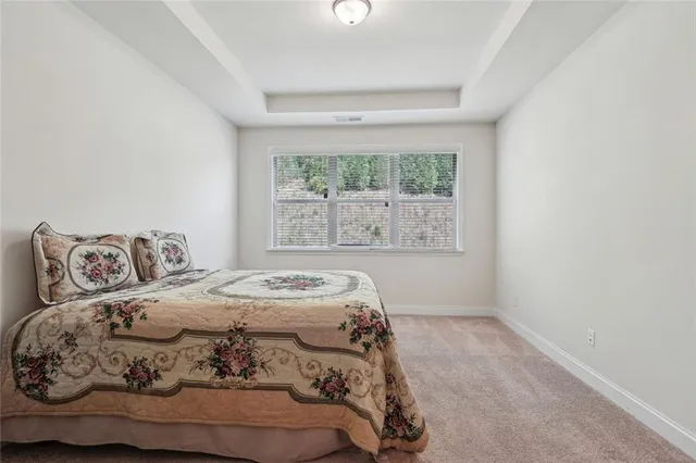 a spacious bedroom with a bed and window