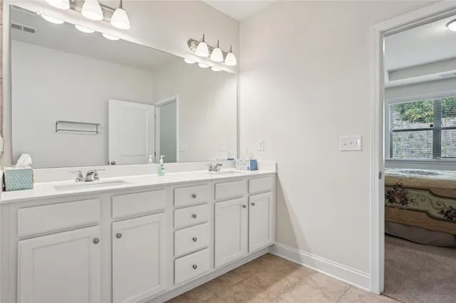 a spacious bathroom with a double vanity sink mirror and double