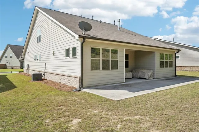a view of a house with large pool and sitting area