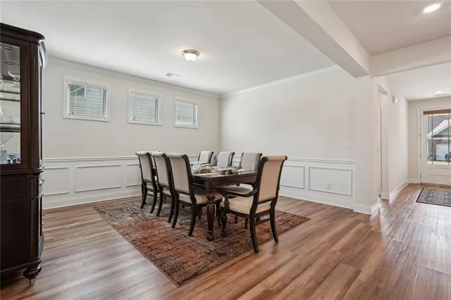 a kitchen with kitchen island stainless steel appliances a dining table and chairs