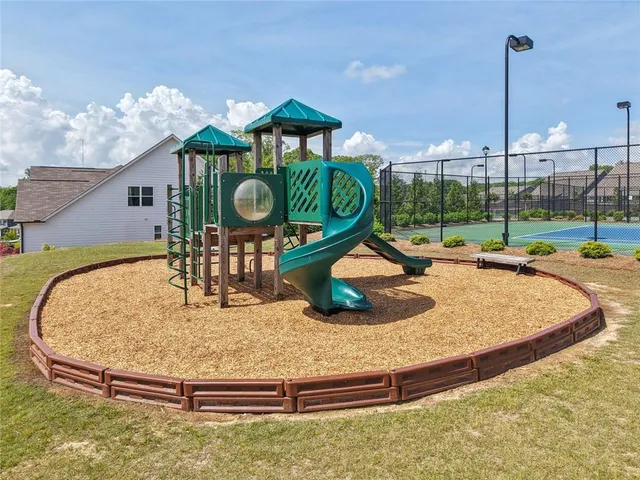 a view of a house with pool and chairs