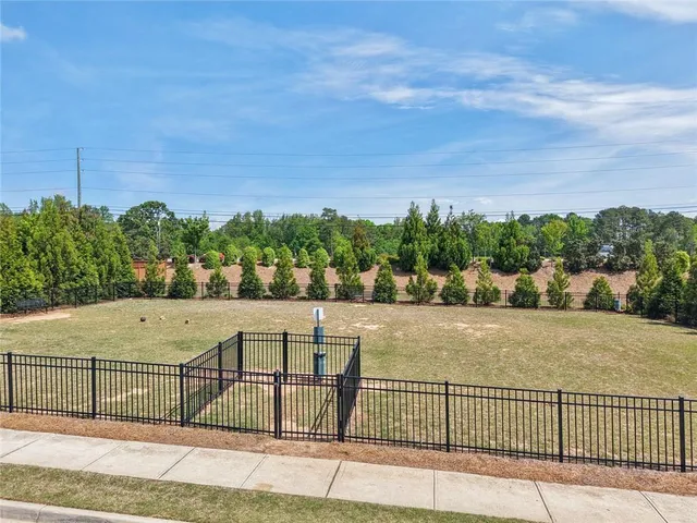 a view of a house with swimming pool and sitting area