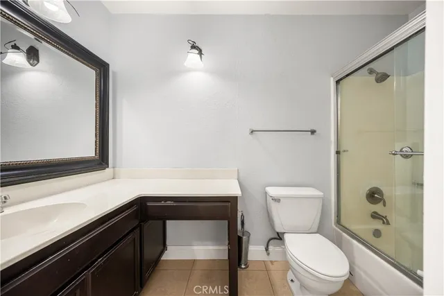 a bathroom with a toilet a sink and shower