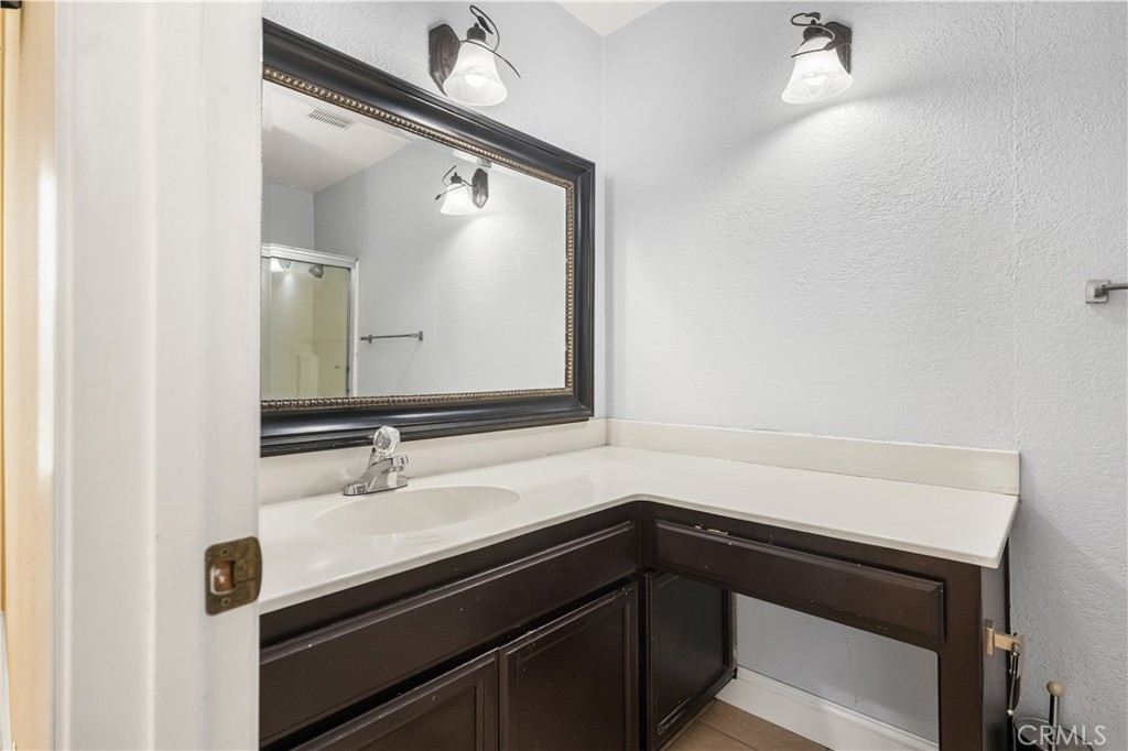 1062 Walnut Street, Unit C Tustin, CA 92780 - Photo 28 of 41 a bathroom with a sink a vanity and a mirror