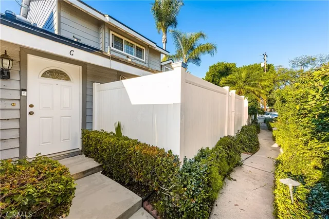 a view of a house with potted plants