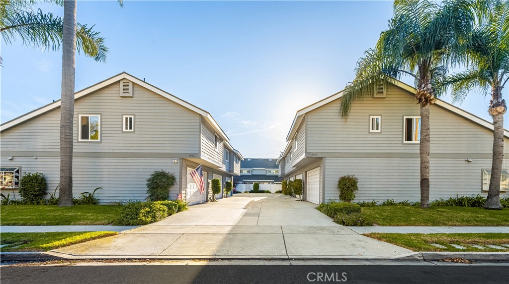 1062 Walnut Street, Unit C Tustin, CA 92780 - Photo 38 of 41 a front view of a house with a yard and garage