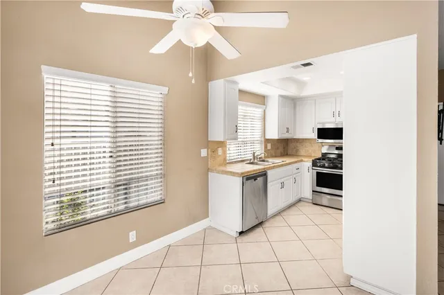 a kitchen with a stove a sink and a microwave