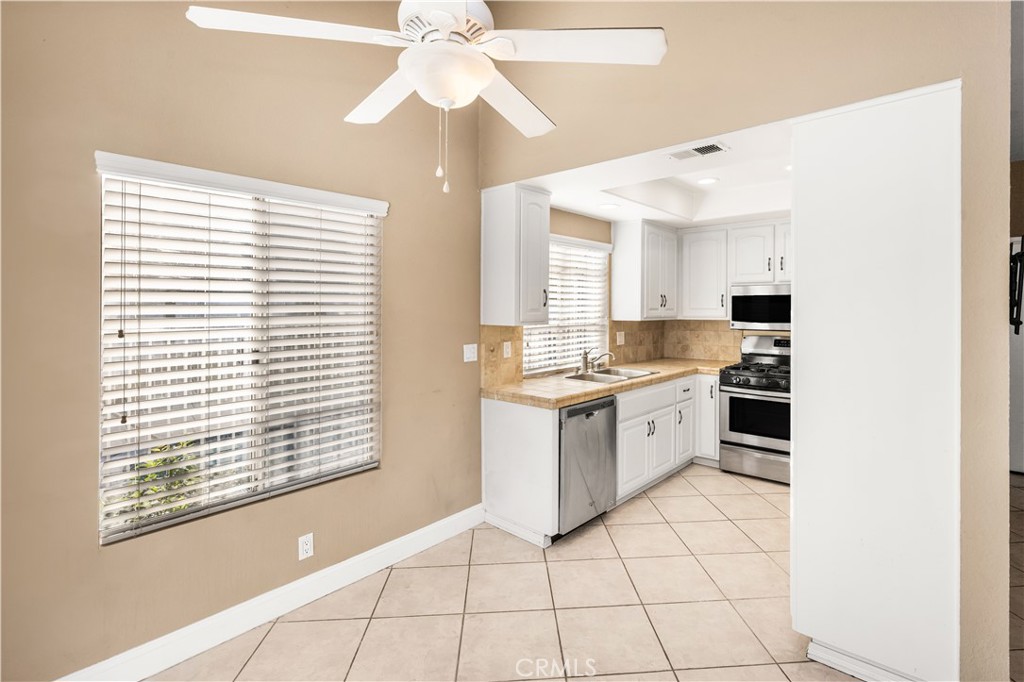 1062 Walnut Street, Unit C Tustin, CA 92780 - Photo 10 of 41 a kitchen with a stove a sink and a microwave