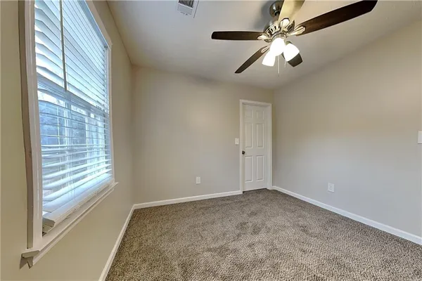 a view of room with window and ceiling fan