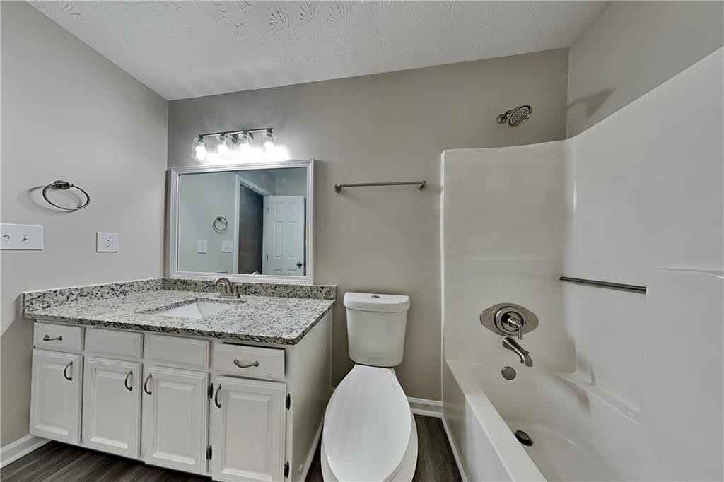 3115 Pond Ridge Trail Snellville, GA 30078 - Photo 15 of 19 a bathroom with a granite countertop sink toilet and shower