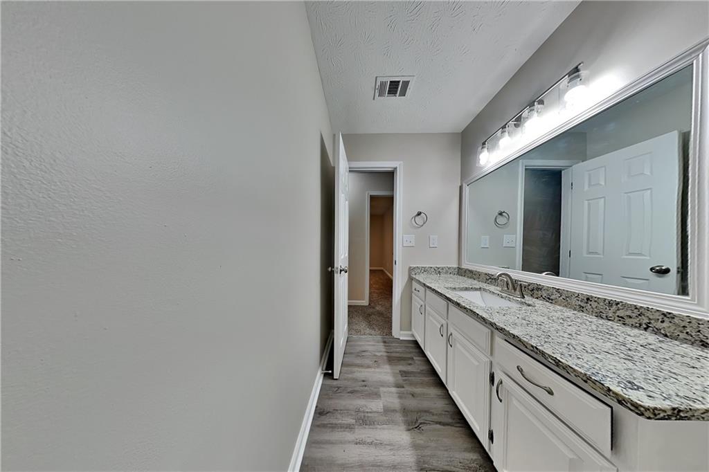 3115 Pond Ridge Trail Snellville, GA 30078 - Photo 16 of 19 a bathroom with a granite countertop sink and a mirror
