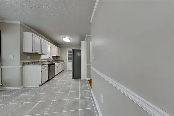 a kitchen with a sink a counter top space and cabinets