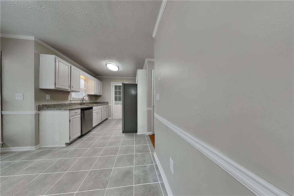 3115 Pond Ridge Trail Snellville, GA 30078 - Photo 4 of 19 a kitchen with a sink a counter top space and cabinets