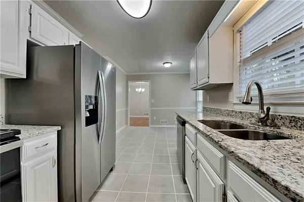 a kitchen with a sink and a refrigerator