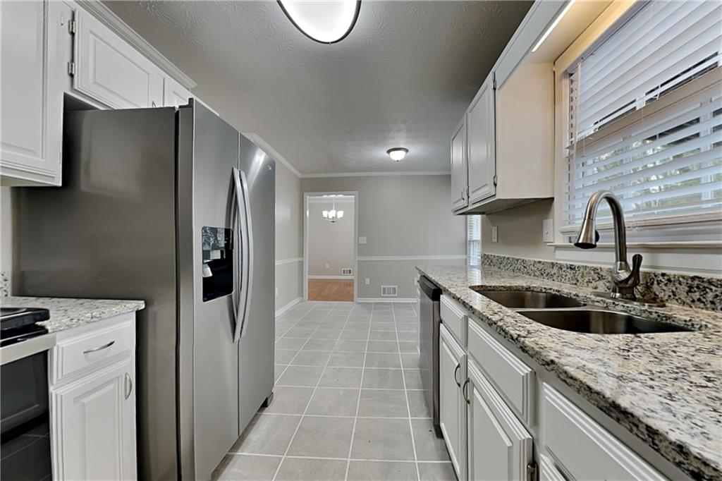 3115 Pond Ridge Trail Snellville, GA 30078 - Photo 5 of 19 a kitchen with a sink and a refrigerator