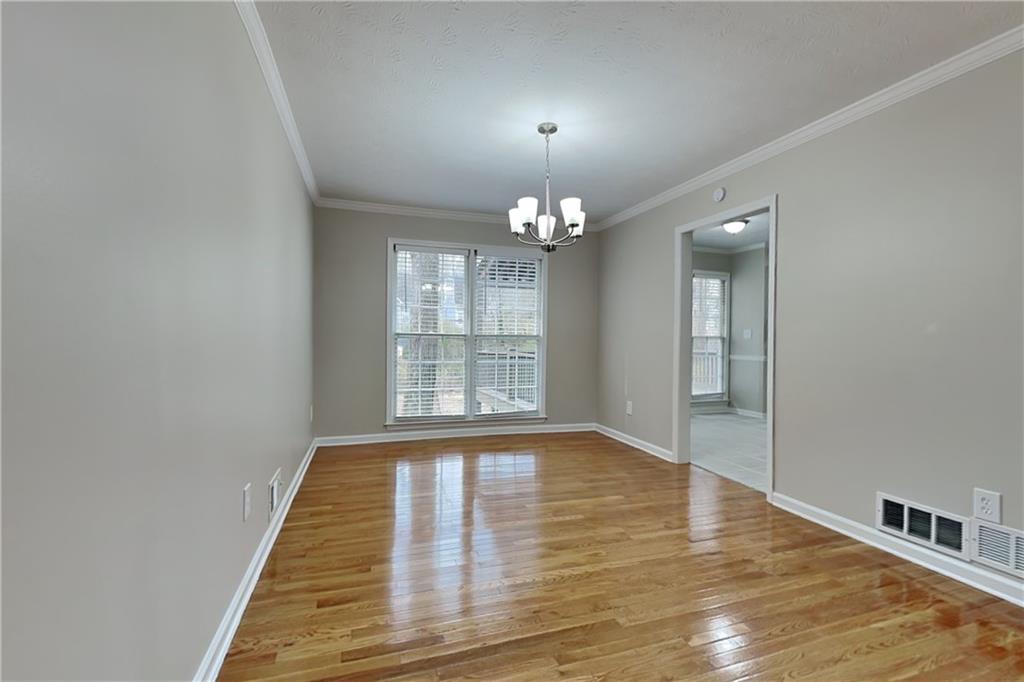 3115 Pond Ridge Trail Snellville, GA 30078 - Photo 7 of 19 a view of an empty room with wooden floor and a window