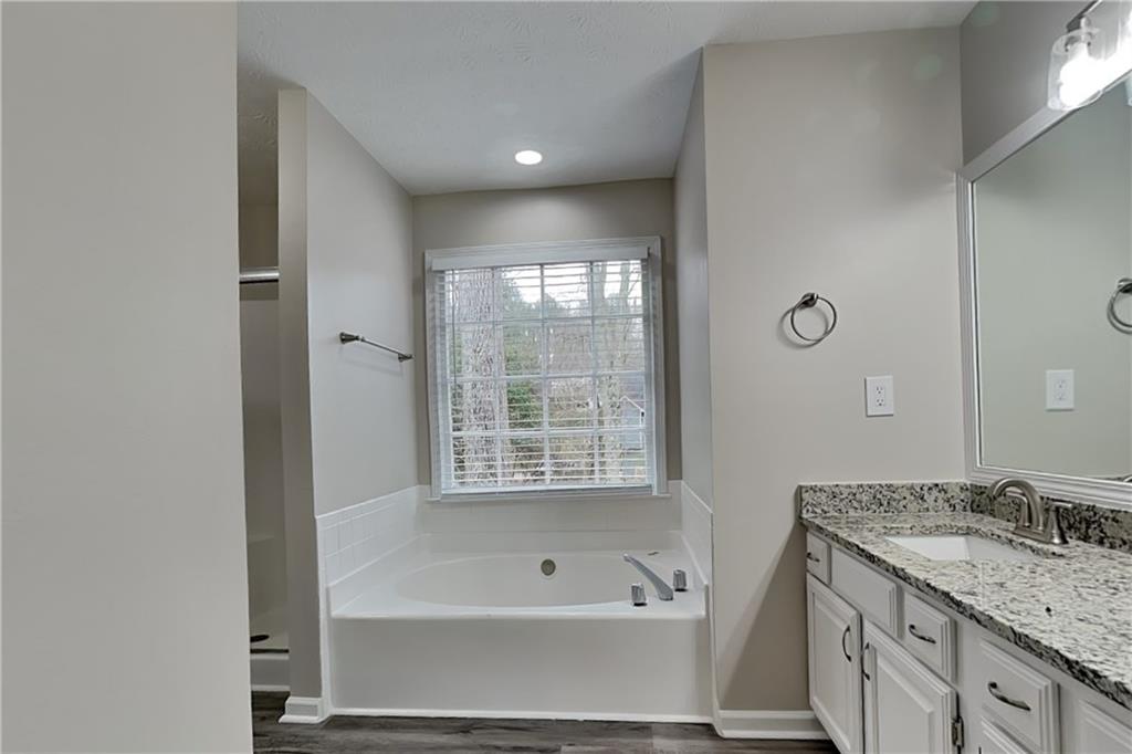 3115 Pond Ridge Trail Snellville, GA 30078 - Photo 9 of 19 a bathroom with a tub sink and mirror