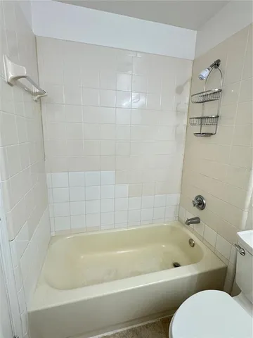 a bathroom with a bathtub and toilet