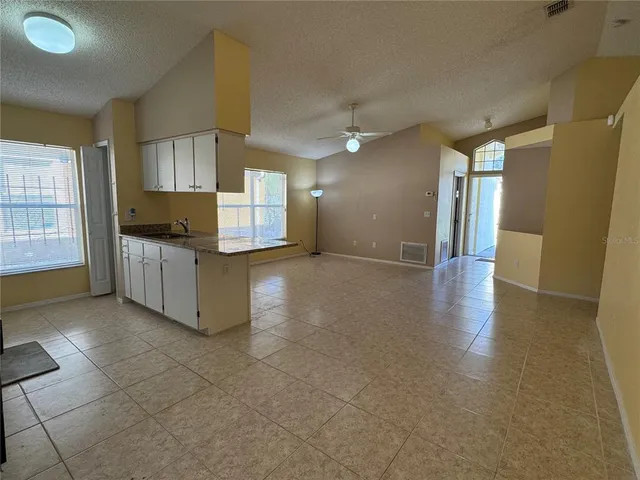 a view of a kitchen with furniture and a window