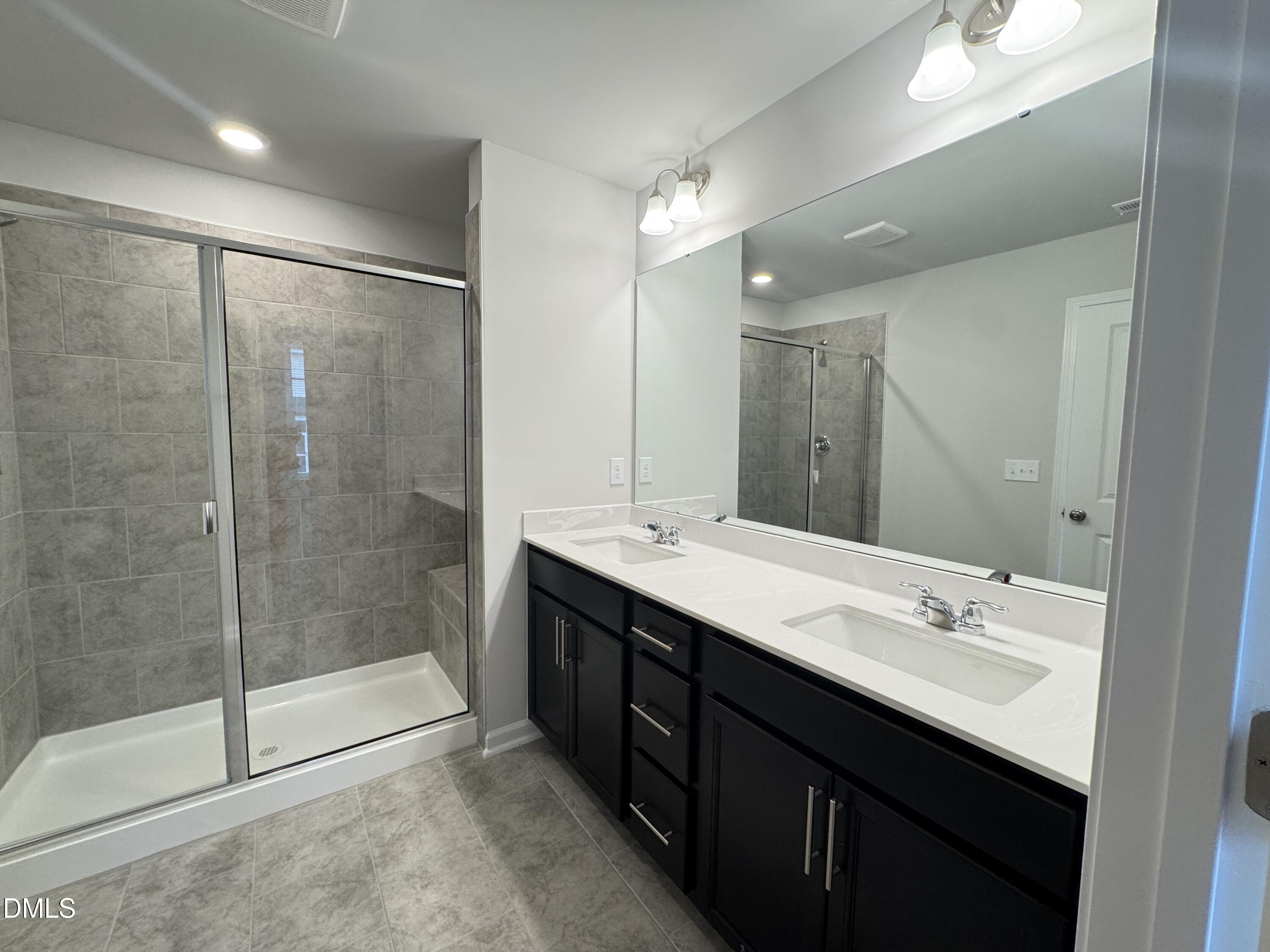 523 Hester Road Durham, NC 27703 - Photo 14 of 21 a bathroom with a double vanity sink mirror and shower