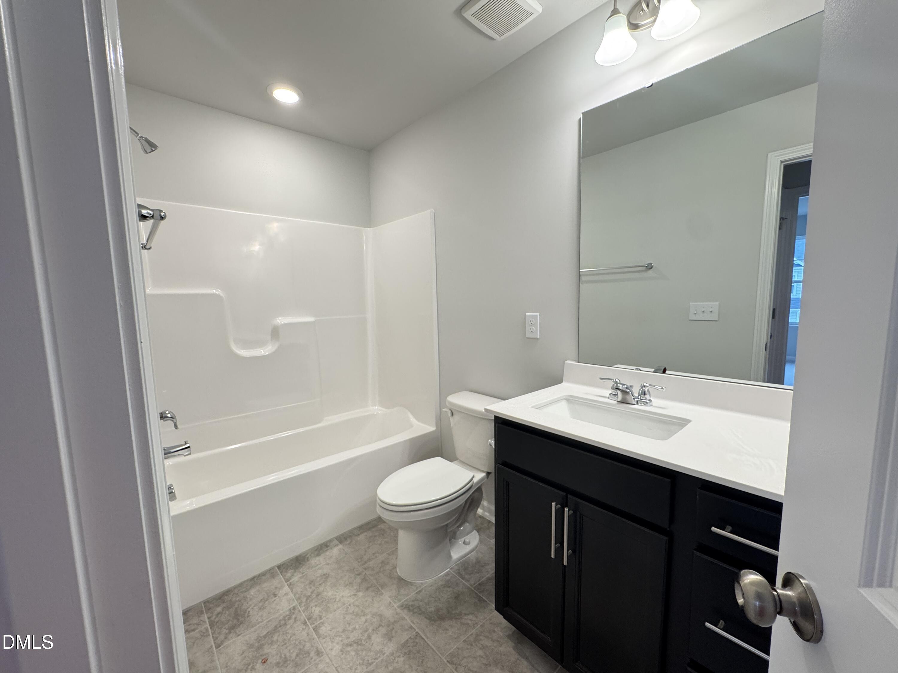 523 Hester Road Durham, NC 27703 - Photo 18 of 21 a bathroom with a sink a toilet and shower