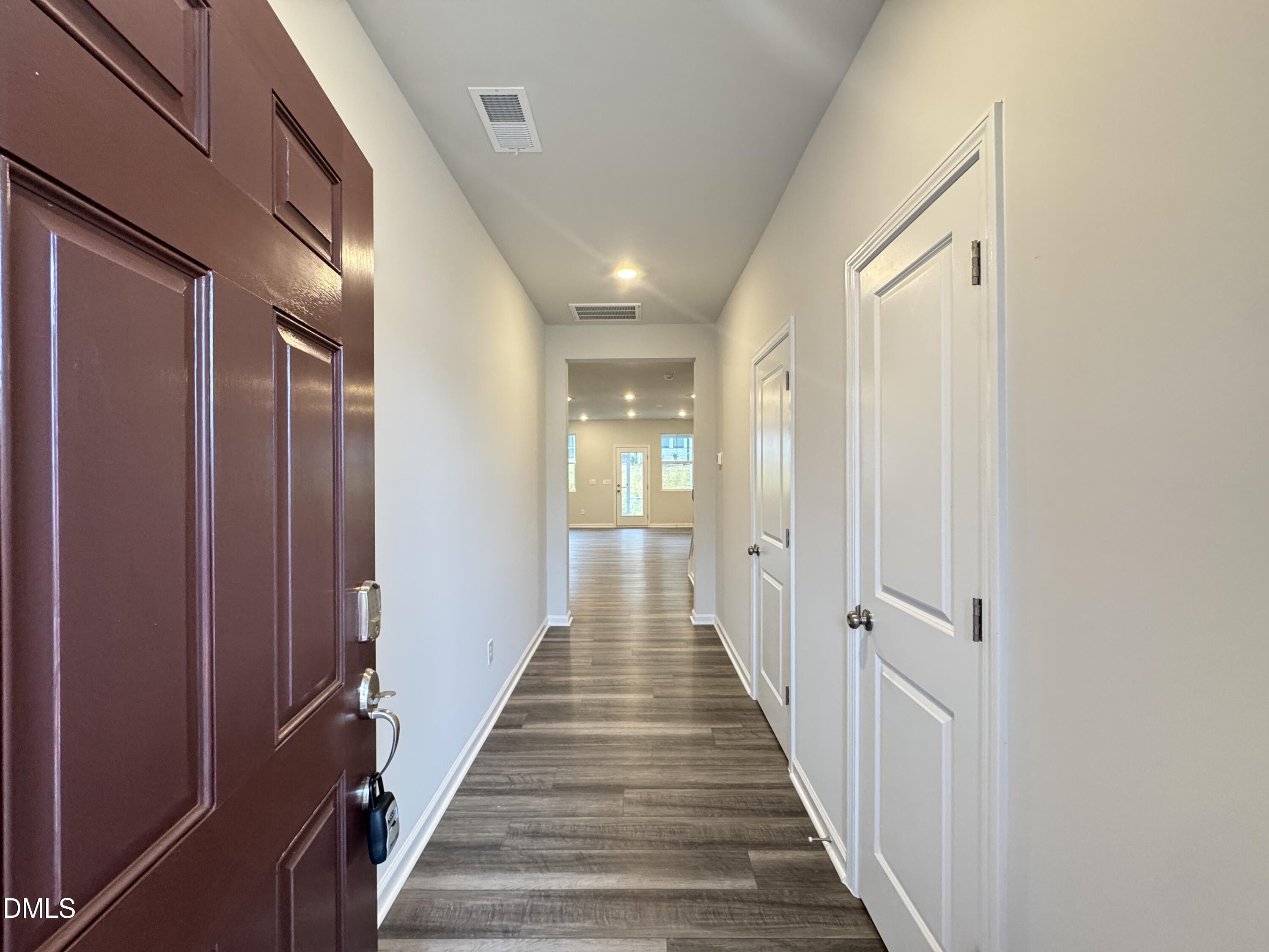 523 Hester Road Durham, NC 27703 - Photo 2 of 21 a view of a hallway with wooden floor and staircase