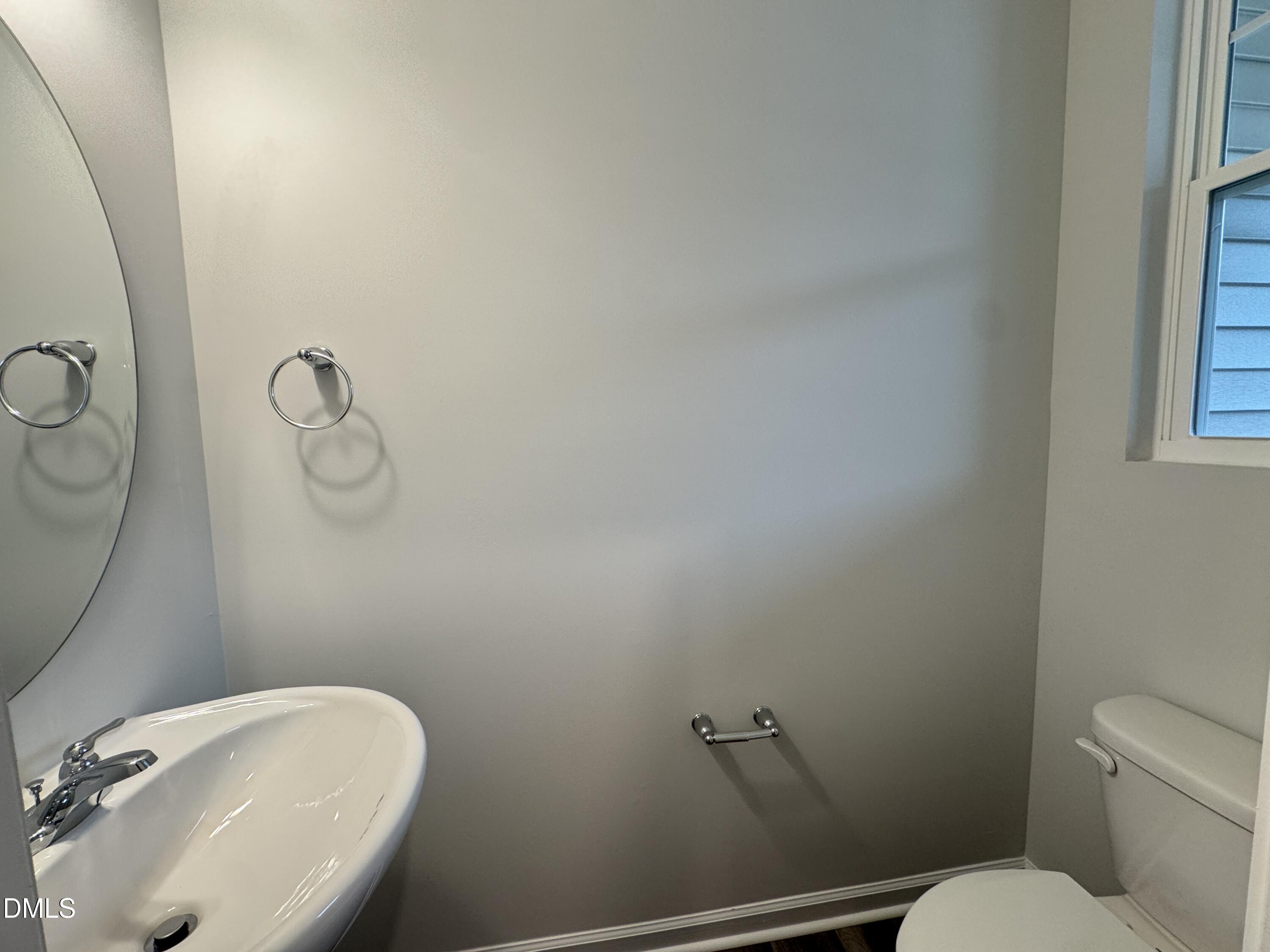 523 Hester Road Durham, NC 27703 - Photo 8 of 21 a bathroom with a toilet sink and mirror