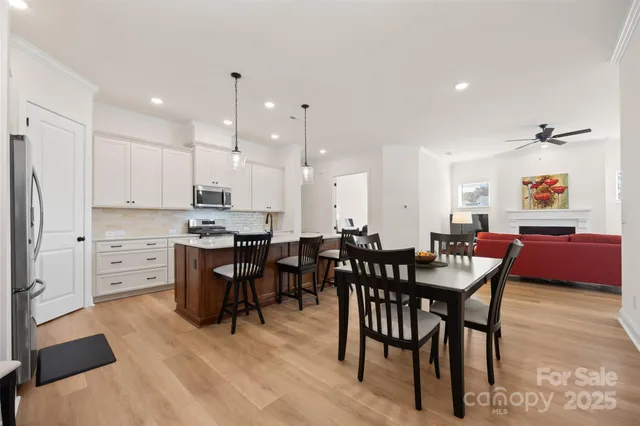 a large kitchen with a table and chairs