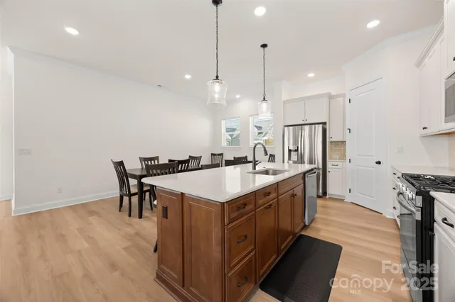 a large kitchen with a table and chairs
