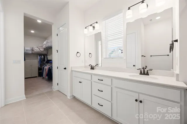 a spacious bathroom with a double vanity sink mirror and double