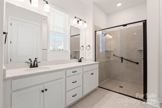 a bathroom with a shower sink and mirror