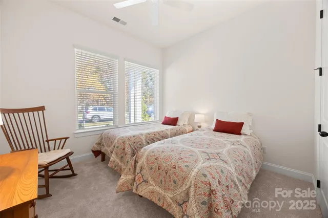 a bedroom with two beds and a window