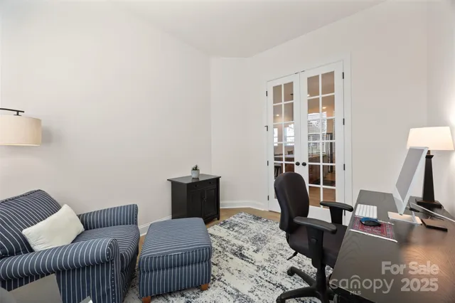 a living room with furniture a flat screen tv and a window