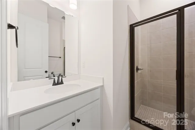a bathroom with a shower and a sink