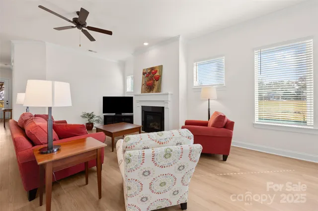a living room with furniture fireplace and a window