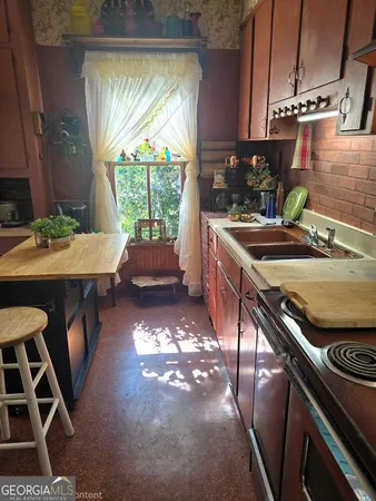 a kitchen with table and chairs
