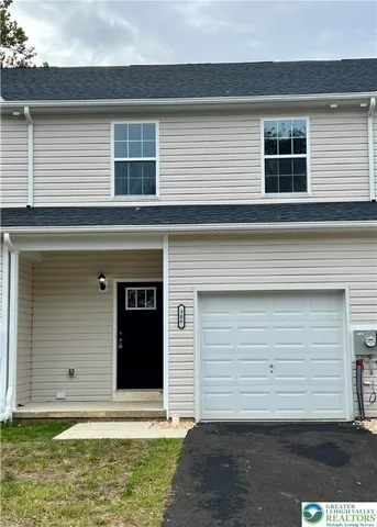 a view of a house with a yard and garage