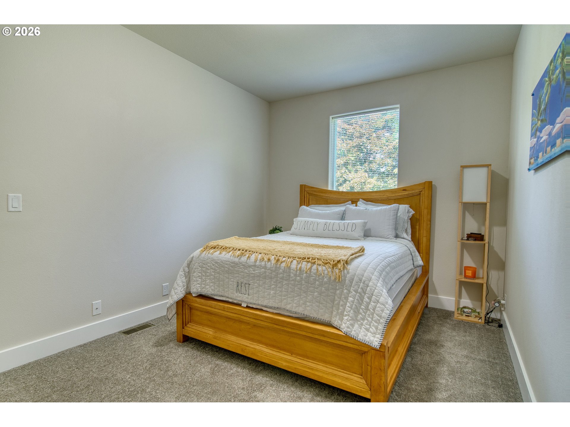 55635 Fullerton Road Warren, OR 97053 - Photo 23 of 42 a bedroom with a bed and a painting on the wall