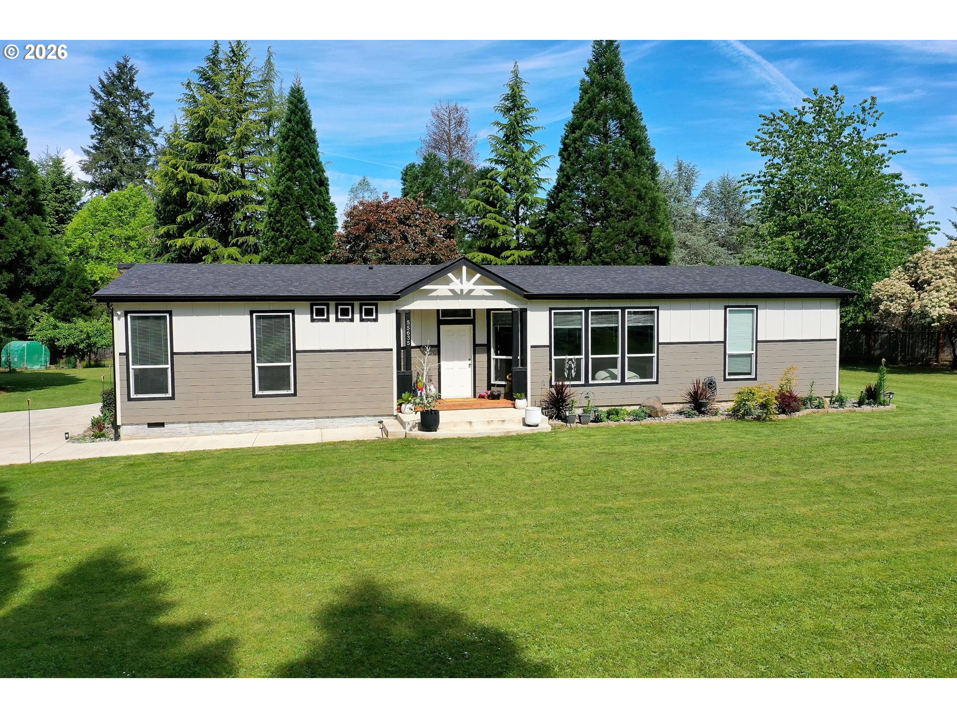 55635 Fullerton Road Warren, OR 97053 - Photo 4 of 42 a front view of a house with a garden