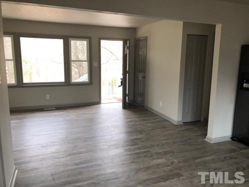 924 Seabrook Road Raleigh, NC 27610 - Photo 5 of 10 an empty room with wooden floor and windows