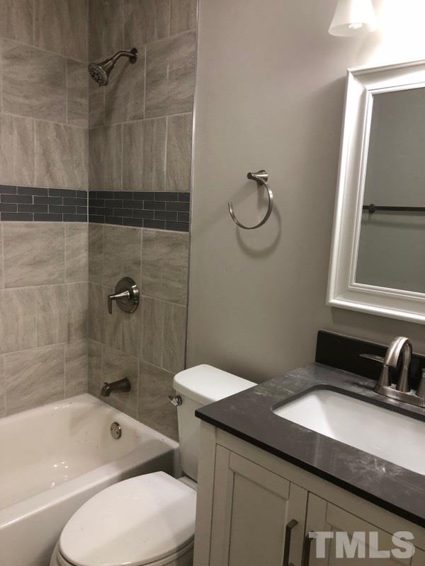 924 Seabrook Road Raleigh, NC 27610 - Photo 7 of 10 a bathroom with a granite countertop sink a toilet and shower