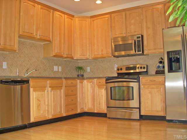 Large kitchen with hardwood floors, breakfast area under the skylight overlooks the golf course. Solid surface counters, stainless appliances -- only the best!