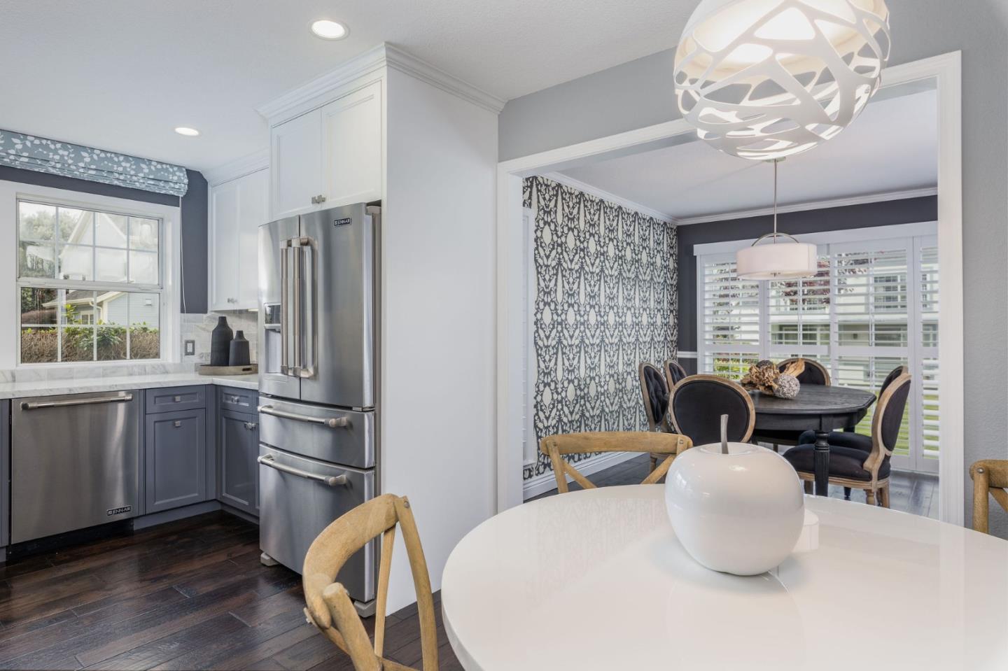 10 Merion Road Half Moon Bay, CA 94019 - Photo 10 of 39 a kitchen with stainless steel appliances granite countertop a refrigerator a stove a sink dishwasher a dining table and chairs with wooden floor