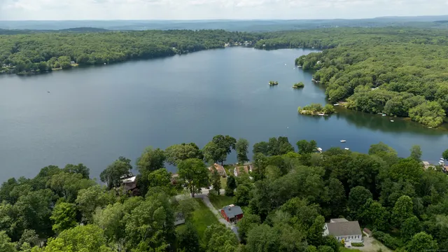 an aerial view of a houses with a lake view
