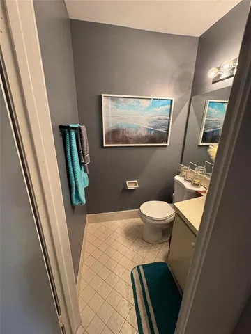 a bathroom with a toilet a sink and a mirror