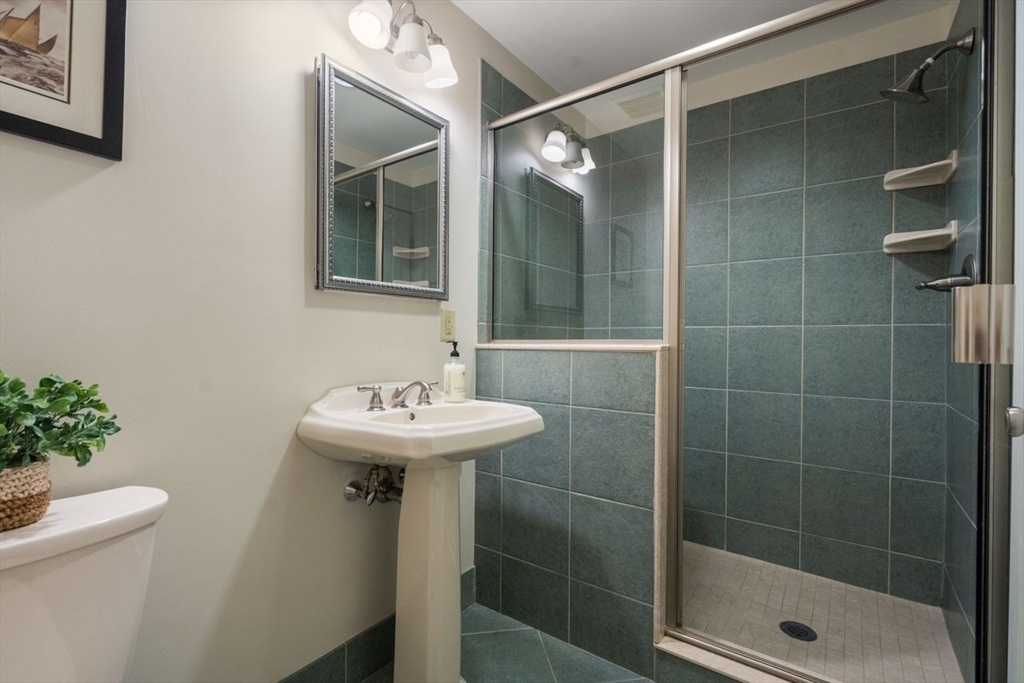53 Winslow Road Brookline, MA 02446 - Photo 11 of 23 a bathroom with a sink a toilet and shower